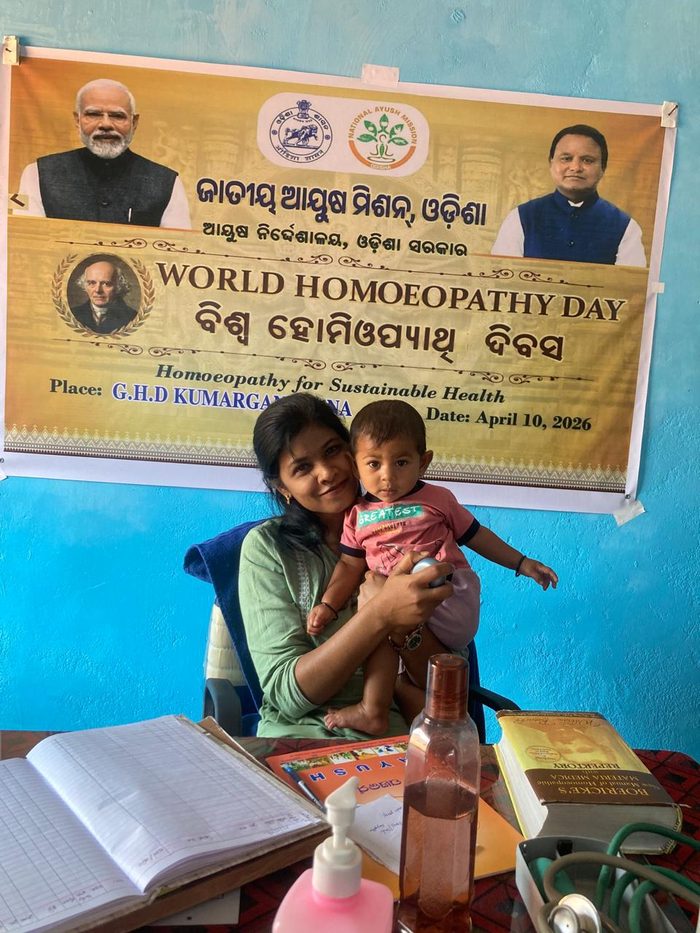 Dr. Rajeswari attending to a young child at the community health camp
